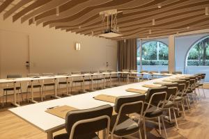a classroom with rows of tables and chairs at H&ocirc;tel Ibaia in Hendaye