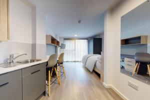 a kitchen with a sink and a bed in a room at Private Bedrooms with Shared Kitchen, Studios and Apartments at Canvas Arundel House in the heart of Coventry in Coventry