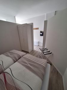 two beds in a small room with two doors at Ferienwohnung Diemel in Bad Karlshafen
