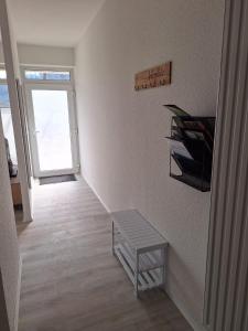 a staircase with a bench in a room with a window at Ferienwohnung Diemel in Bad Karlshafen