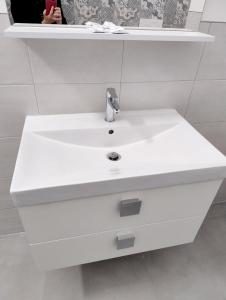 a white sink with a faucet in a bathroom at A ca de RITA in Albenga