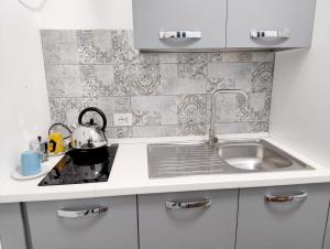a kitchen counter with a sink and a stove at A ca de RITA in Albenga