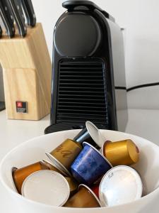 a bowl filled with medicines and a toaster on a counter at feworld living - Deutsch Wagram bei Wien in Deutsch-Wagram