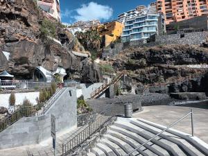 a set of stairs in a city with buildings at Amejica - Apartment with terrace and sea view in Tabaiba