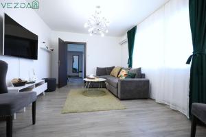 a living room with a couch and a table at Vezda 19 in Orşova