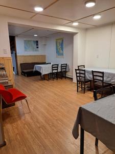 una habitación con mesas y sillas en Hotel Condor de Plata, en Punta Arenas