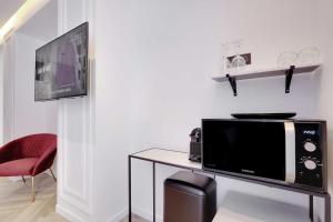 a microwave sitting on a table in a room at Lovely Bedroom with Jacuzzi 2P Chatelet in Paris