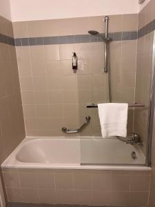 a bath tub in a bathroom with a towel at Hotel De Champoluc in Champoluc