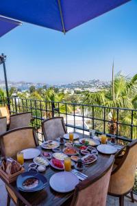 a table with food on a balcony with a view at Bombien Luxury in Bodrum City +32 photos