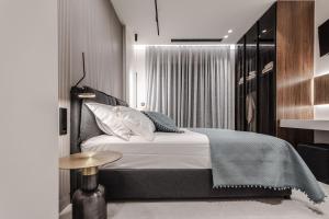 a bedroom with a bed and a side table at Kolchis Urban Villas in Volos +34 photos