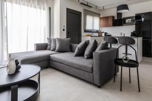 a living room with a couch and two tables at Kolchis Urban Villas in Volos