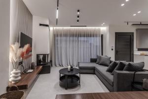 a living room with a couch and a table at Kolchis Urban Villas in Volos