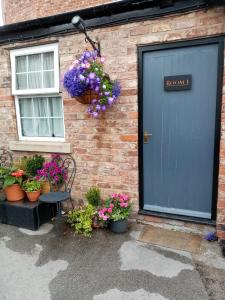 a blue door on a brick building with potted plants at Masons Arms in York