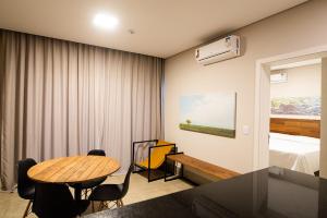 a room with a table and chairs and a bed at Tayayá Aqua Resort in Ribeirão Claro
