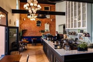 a woman standing at the bar of a restaurant at GRAND CENTRAL LJUTOMER in Ljutomer