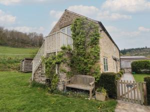 a stone house with a bench in front of it at The Burrows in York
