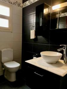 a bathroom with a sink and a toilet and a window at 3Bedroom next to Downtown Mall New Cairo in Cairo
