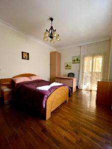a bedroom with a bed and a wooden floor at 3Bedroom next to Downtown Mall New Cairo in Cairo