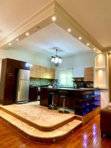 a large kitchen with a island in the middle at 3Bedroom next to Downtown Mall New Cairo in Cairo