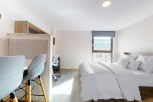 a white bedroom with a bed and a desk at Private Bedrooms with Shared Kitchen, Studios and Apartments at Canvas Glasgow near the City Centre for Students Only in Glasgow