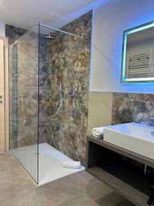a bathroom with a shower and a sink and a tub at Apartments in Pieve di Ledro/Ledrosee 22704 in Ledro