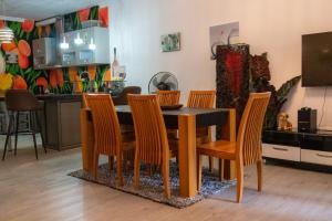 a dining room table and chairs in a kitchen at OTF Rooms & Apartments in Belle Mare