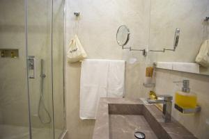 La salle de bains est pourvue d'une douche et d'un lavabo. dans l'établissement Domus Deorum Deluxe, à Naples