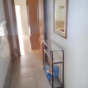 einen Flur mit einem Glasregal und einem Spiegel in der Unterkunft 3 bedrooms apartement at Ciudad Real in Ciudad Real