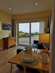 a living room with a table with dishes on it at Beautiful one bed apartment with stunning sea view in Waterford