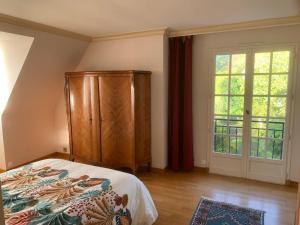 a bedroom with a bed and a large window at Maison vue mer baie de Saint Brieuc in Plérin