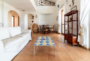 a living room with a white couch and a table at Villa Moscariello - Beach & Sea in Ascea +34 photos