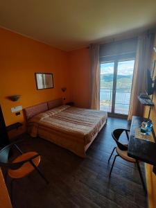 Postel nebo postele na pokoji v ubytování Hotel Panoramico SPA lago d'Orta