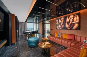 a living room with a couch and a table at Desire Riviera Maya Resort All Inclusive - Couples Only in Puerto Morelos