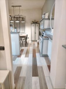 a kitchen and dining room with a wooden floor at 2 bedrooms apartement with furnished garden and wifi at Coppe in Coppe
