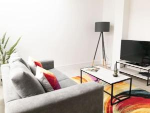 a living room with a couch and a tv at Zenith at Fleet Heights Apartment Three in Fleet