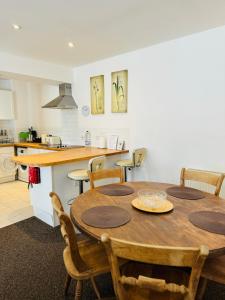 Il comprend une cuisine et une salle à manger avec une table et des chaises en bois. dans l'établissement Modern house in central St Leonards, à Hastings
