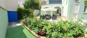 a garden with some plants and an umbrella at Pratza Froria in Villasimius +34 photos