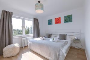 a bedroom with a bed with two teddy bears on it at Pins Dorés - A Luxurious and beautifully decorated villa with terrace and parking near the beach in Knokke-Heist
