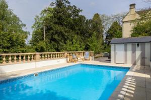 a swimming pool in a backyard with a fence at The New School Rooms - Beautiful, Georgian Apartment with Private Heated Pool and Hot Tub Sleeps 12 with Wifi and Parking near Bath in Box