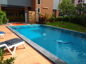 a swimming pool with a person in the water at The Right Resort in Pattaya