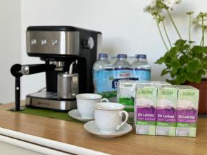 a counter with cups of coffee and a coffee maker at Encantadora casa en el corazón de Estepona in Estepona