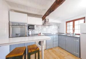 a kitchen with blue cabinets and white appliances at La Casina de la Peña in Luarca