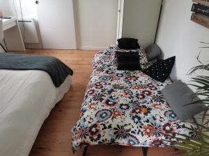 a bedroom with a bed with a blanket on it at L'atelier de Jane in Sennecey-lès-Dijon