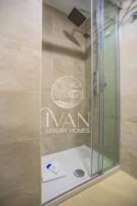 a bathroom with a shower with a sign on the wall at Casa Claudia Ivan Luxury Homes 5ªPlta Sur 1ªLinea in Oropesa del Mar