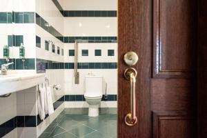 a bathroom with a toilet and a sink at Vila Gale Ericeira in Ericeira