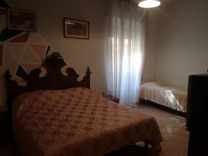 a bedroom with a bed and a window at APE REGINA Rignano extension in Rignano Flaminio