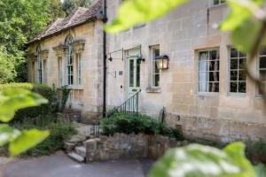 a stone house with a staircase leading to the door at The Old School Rooms Beautiful Georgian apartment, sleeps 12 with Wifi and Parking, near Bath in Box