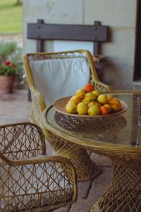 a table with a bowl of fruit on it at Hotel Palacio La Casona de Cerrazo in Cerrazo