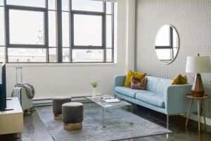 Sonder Le Guerin في مونتريال: غرفة معيشة مع أريكة زرقاء وطاولة