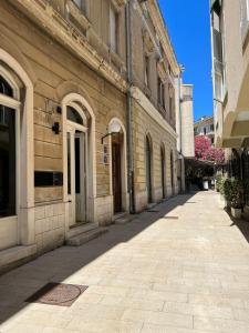an empty street in front of a building at Max's downtown oasis in Zadar